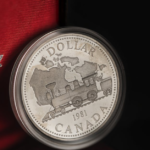 Detailed view of a 1981 Canadian silver dollar featuring a train design in an elegant case.